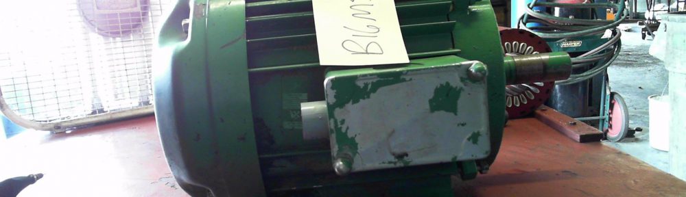 Green electric motor on workbench